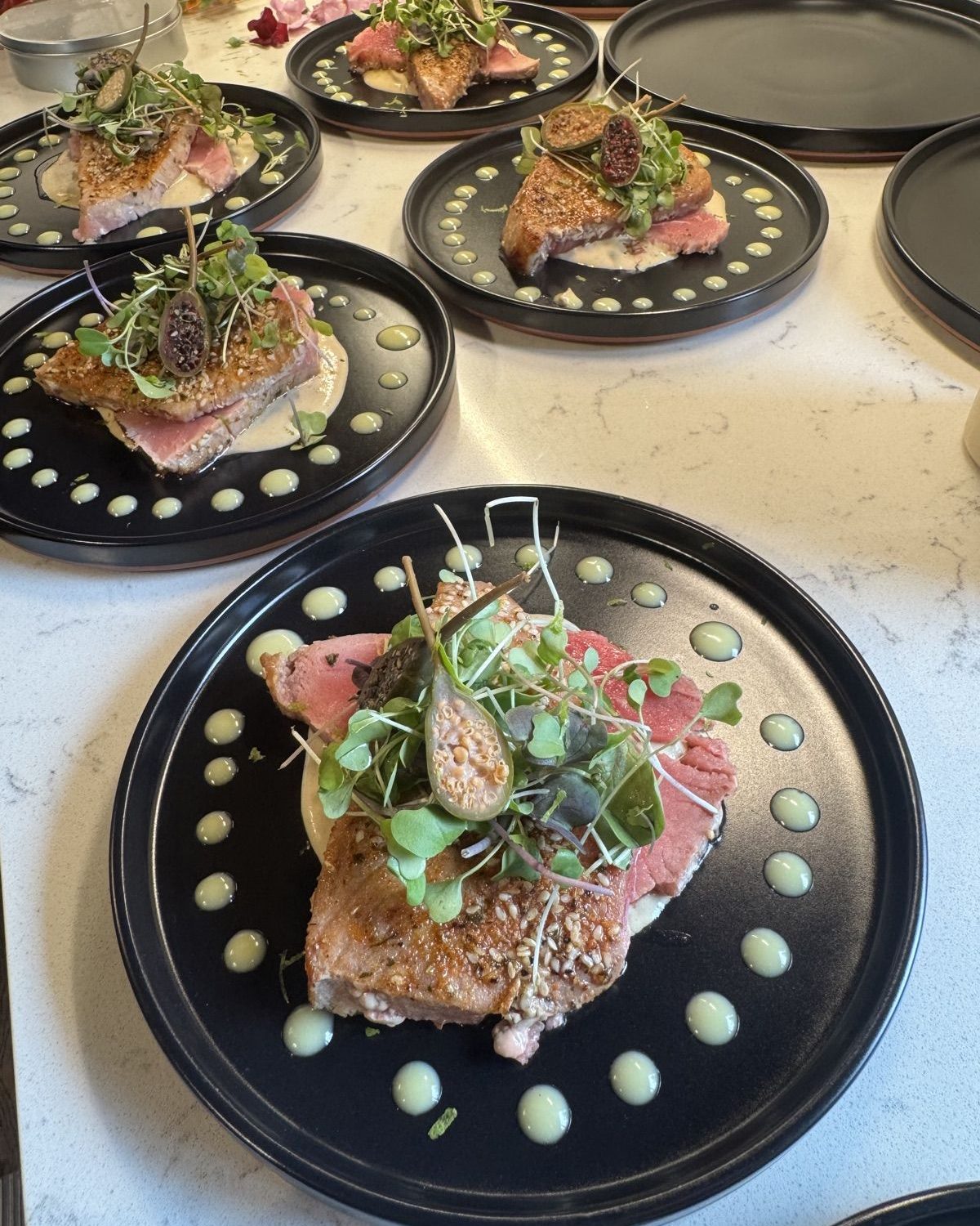 Production line of seared tuna plates with microgreens and fig