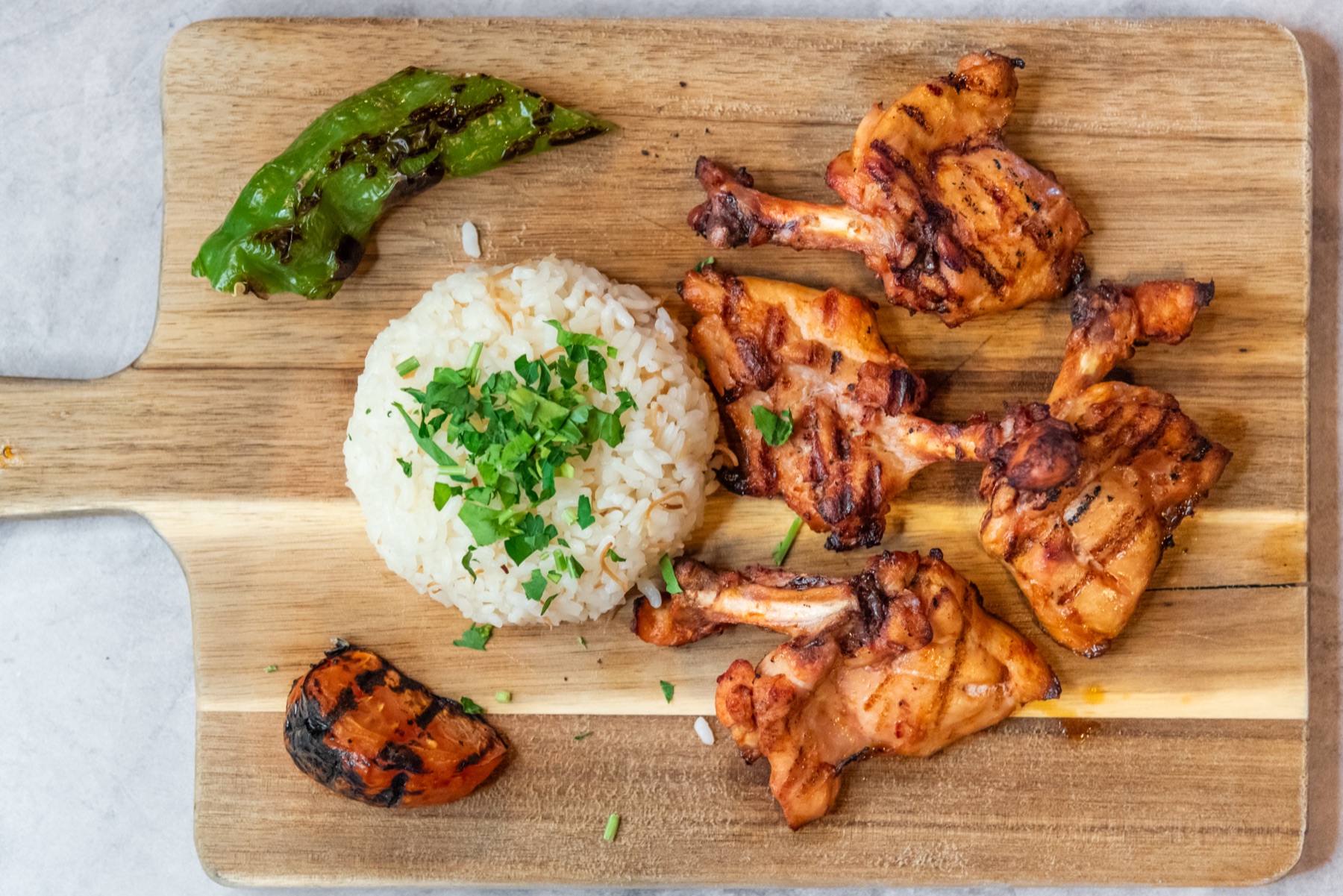 Grilled chicken plate with rice and greens