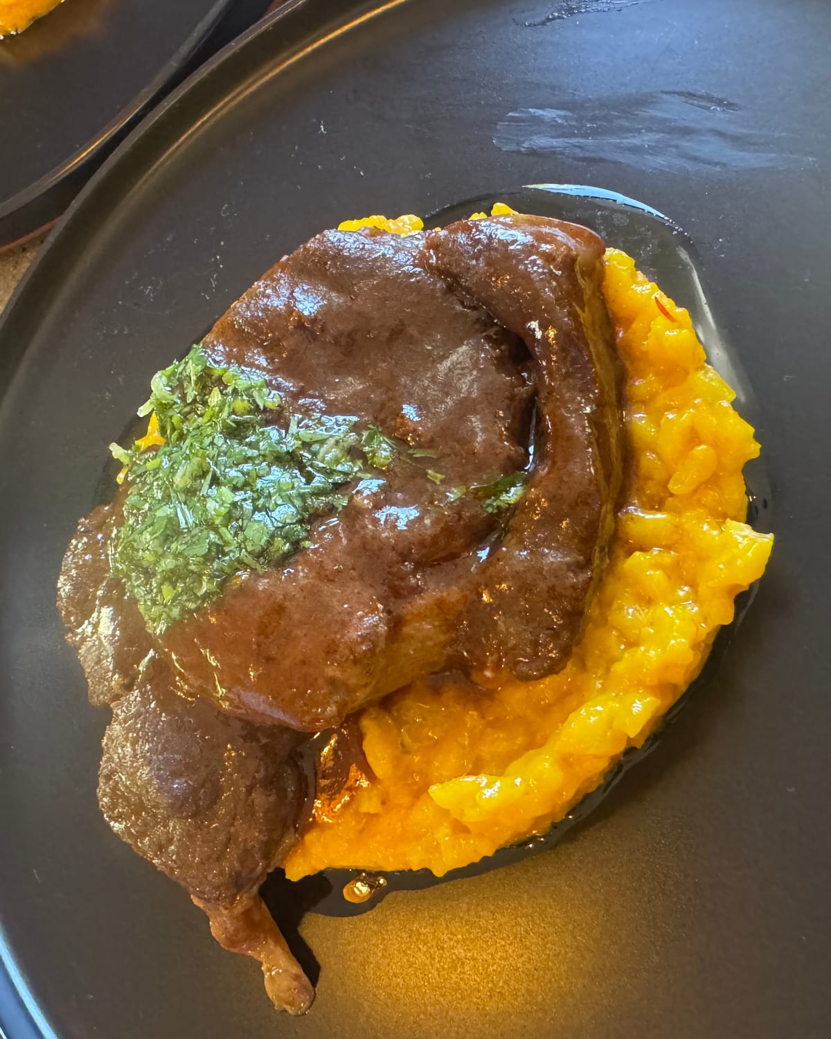 Glazed short rib on yellow risotto with herb sauce
