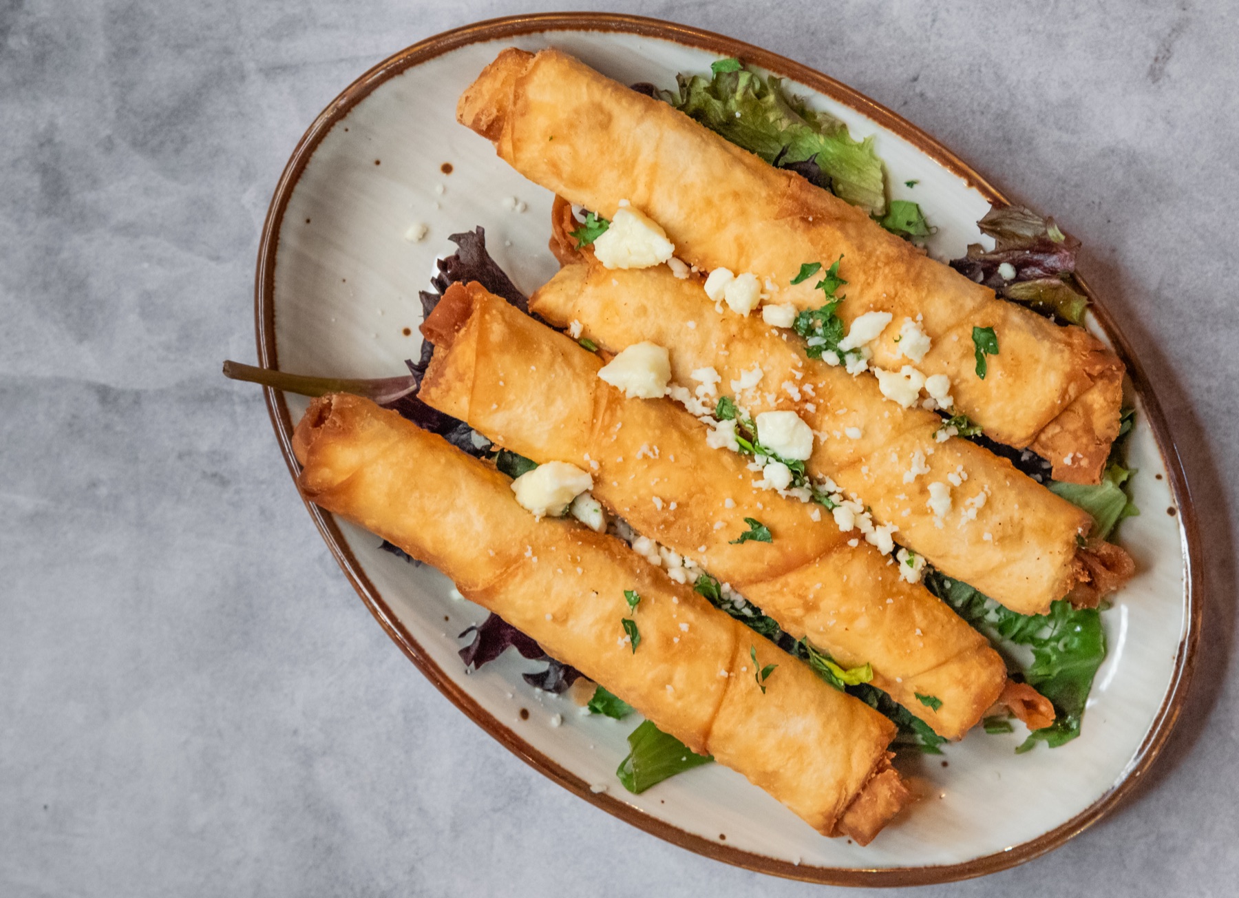 Long plated rolls with herbs and garnish