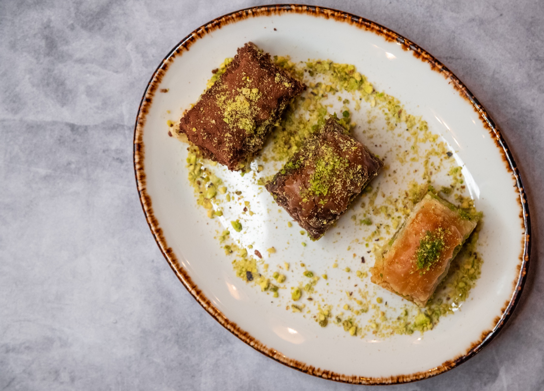 Pistachio pastry pieces plated with garnish