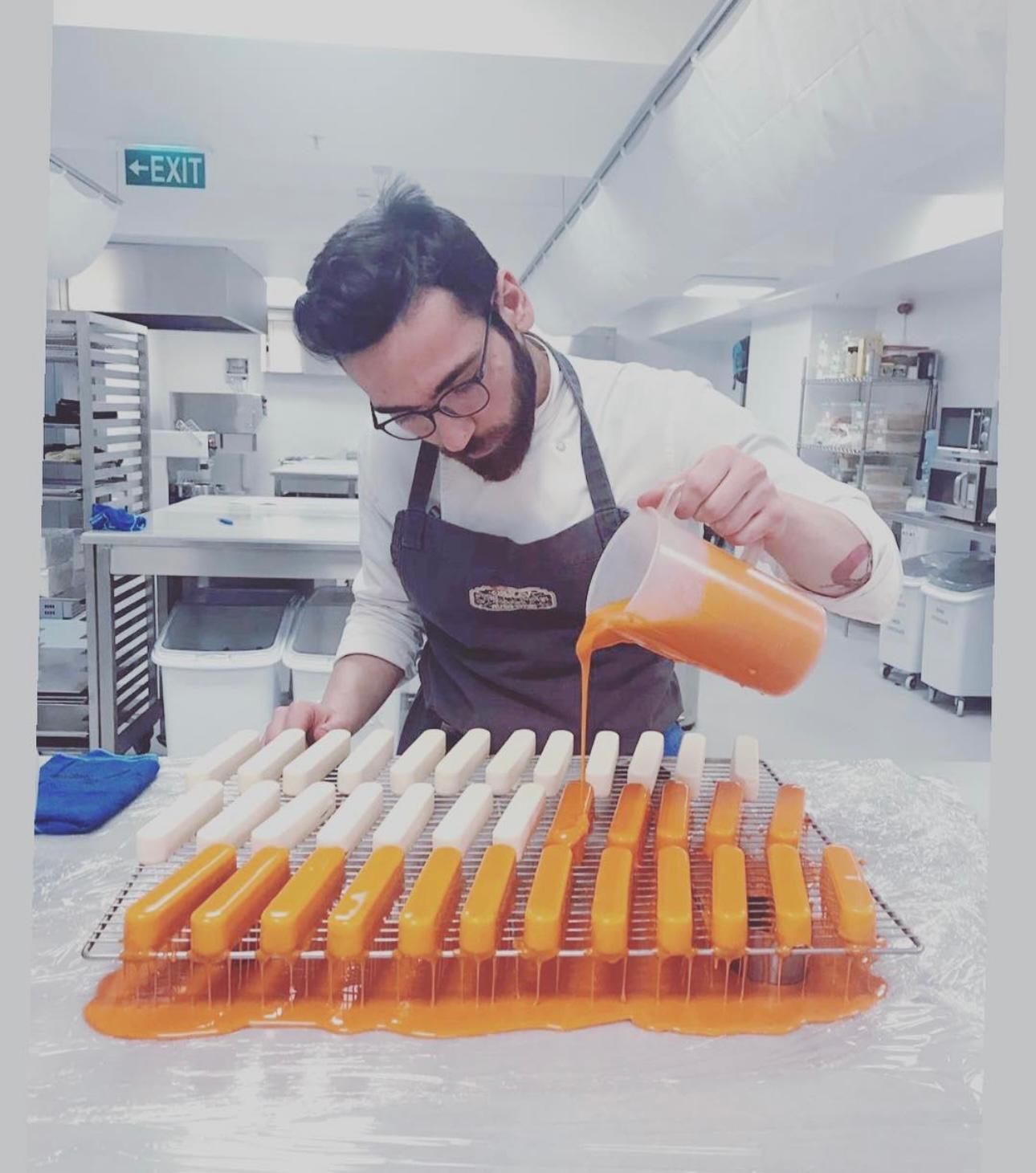 Chef Fikret Siler glazing mango cheesecake