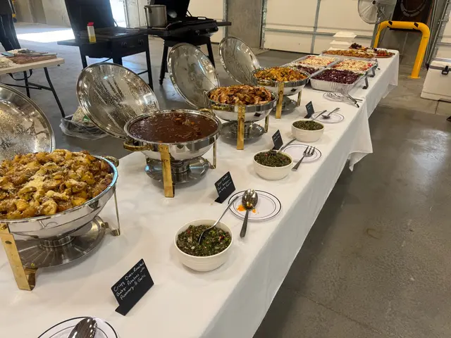 Professional on-site catering buffet with labeled chafing dishes