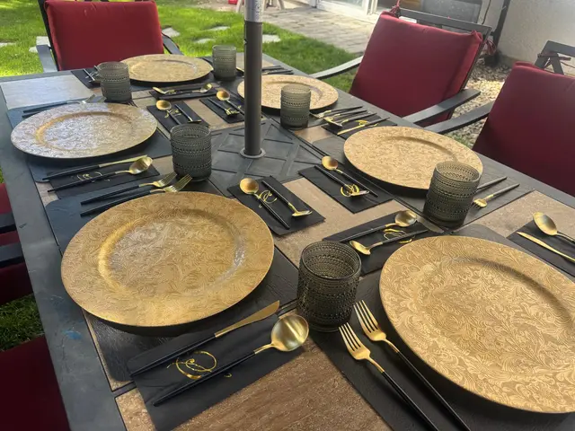 Outdoor private dining table set with gold chargers for on-site chef service